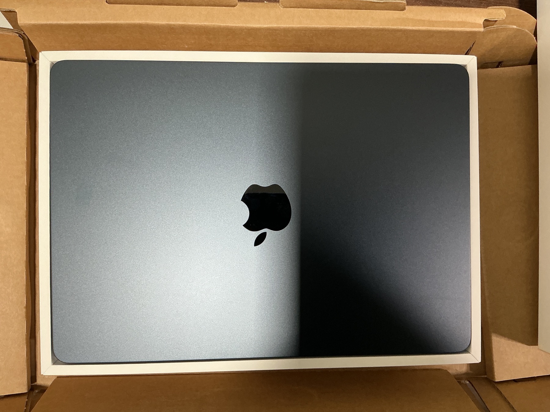 The MacBook Air's midnight finish revealed in its box