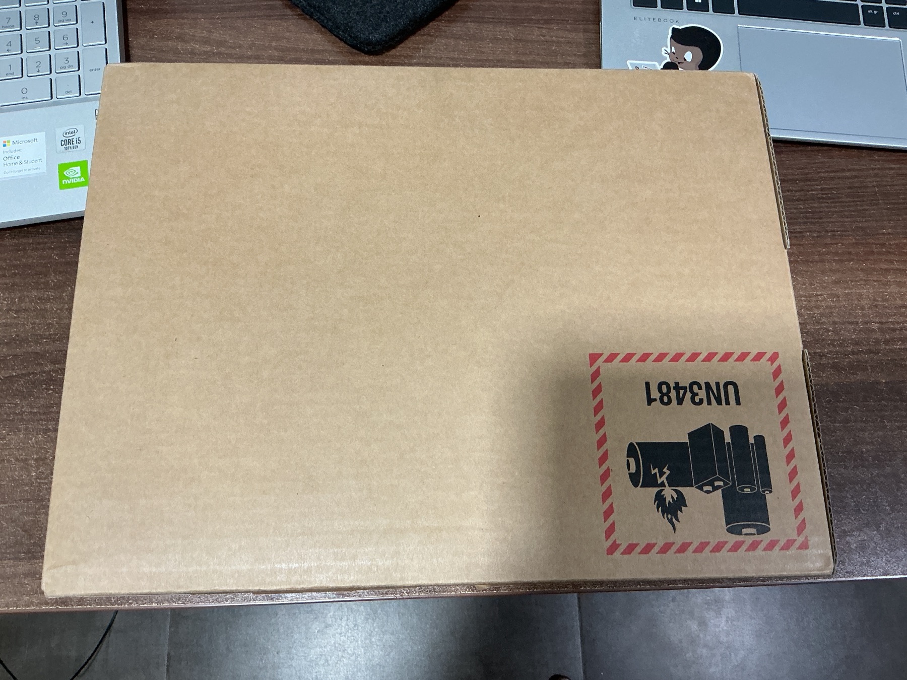 The unopened shipping carton beside my old laptops