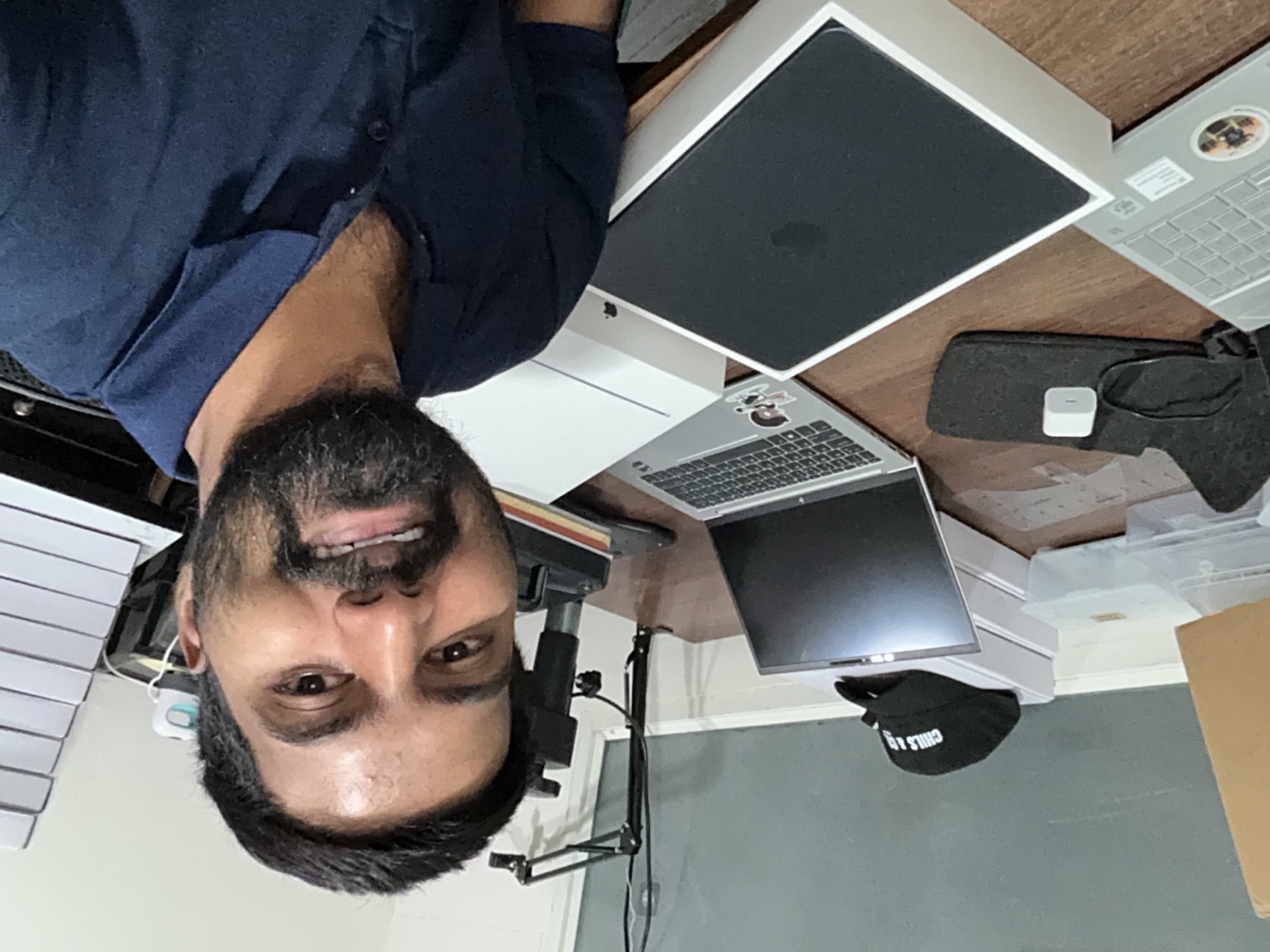 Uday beside his new MacBook Air at his desk